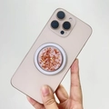 Detail of MagSafe phone grip with gold foil flakes and pink resin finish on a smartphone - Magnetic Stand / White Base Rose Gold Foil