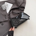 Glossy black shoulder bag with silver studs and punk style in a fashion setting - Black