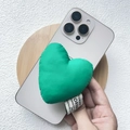 Close-up of green padded fabric heart phone stand with woven label on iPhone - Magnetic Stand / Green Cotton Heart