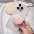 Dettaglio del supporto per telefono a conchiglia rosa con perle e glitter in resina - Supporto Magnetico / Conchiglia di Sabbie Mobili Arancione Sfumato