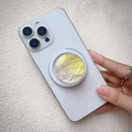 Macro shot of a gradient shell magnetic phone holder on a white smartphone - Magnetic Stand / Yellow Gradient Shell