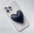 Detail of a black quilted heart phone grip with soft padded texture on a smartphone - Magnetic Stand / Black Fabric Heart