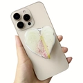 Heart-shaped magnetic acrylic phone grip with white leaf patterns on a smartphone - White Plant Natural Spotted (5)