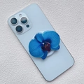 Close-up of blue orchid acrylic magnetic phone grip on a light blue smartphone - Blue Orchid Style (32)
