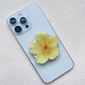 Close-up of yellow orchid acrylic magnetic phone holder on a light blue smartphone - Bright Yellow Five Petal Flower Style (14)