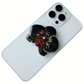 Magnetic orchid phone grip with black and yellow petals on a white smartphone - Black With Yellow Spotted Orchid Style (30)