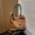 Woven straw tote bag featuring blue fuzzy handle and colorful crochet bow decorations - Khaki