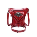 Red steampunk gothic leg bag in patent leather with silver skull and studs on white background - Red