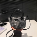 Minimalist woven bucket bag in monochrome pattern with black leather drawstring and handles - Black