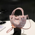 Pink and white woven bucket bag with drawstring closure and crossbody strap detail - Light Pink