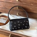 Chic black litchi leather underarm bag with silver grommets and metallic punk details - Black