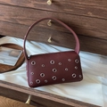 Dark burgundy underarm bag with silver eyelets and lychee grain leather texture - Burgundy