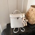 White pebbled leather vanity bag with plush dog charm and silver metal hardware - White
