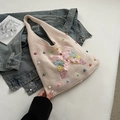 Beige knit tote bag featuring colorful butterfly embroidery and scattered pearls on denim - Light Pink