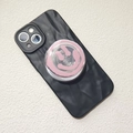 Dettaglio custodia nera ondulata con supporto per telefono a forma di faccina rosa su bianco - Supporto Magnetico / Faccina Sorridente Rosa