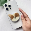 Close-up of a cute acrylic puppy phone grip attached to a white smartphone back - Corgi Dog