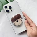 Close-up of a cute brown and white cartoon dog phone socket grip on a white smartphone - Schnauzer Dog