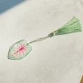 Detail of acrylic leaf bookmark with red vein pattern and green silk tassel - Red Vein Caladium Style (4)