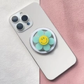 Dettaglio del supporto per telefono a fiore verde menta con smiley su smartphone bianco - Fiore Sorridente Celeste