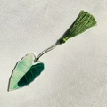Detail of green acrylic leaf bookmark with matching silk tassel on white textured paper - Alocasia Splicing Green Style (7)