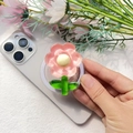 Dettaglio di un supporto floreale in acrilico rosa traslucido con centro giallo su smartphone - Supporto Magnetico / Girasole-Rosa