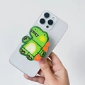Detail of cute green dinosaur acrylic phone socket holder with glossy finish on hand - Green Dinosaur