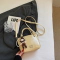 Chic cream-colored bucket bag with metallic logo, plush charm and pearl chain - Yellow With Pendant