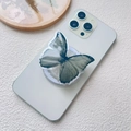 Detailansicht eines halbtransparenten schmetterlingsförmigen Handyhalters aus Acryl in Graugrün - Magnetischer Ständer / Coole Schwarze Schmetterling