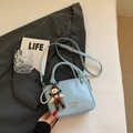 Pale blue textured leather bucket bag with cute doll pendant and pearl chain - Blue with Pendant