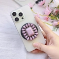 Detail of flower-shaped pink stone phone grip with magnetic base on a smartphone - Pink Cracked Stone Petal Shape (Songshi-9)