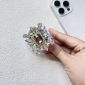 Detail of luxury rhinestone phone socket with colorful crystal gems and Magsafe magnet - Iridescent Gradient Green Rhinestone