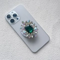 Macro detail of luxury magnetic phone grip with green gemstone and diamond inlay - Magnetic Airbag Stand / Emerald