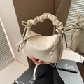 Chic beige pleated handle handbag with bow accents and mirror reflection aesthetic - Off White