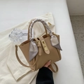 Chic apricot bucket bag in grain leather with a geometric patterned silk scarf handle - Khaki