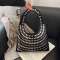 Minimalist black crescent handbag with silver rivets and glossy faux leather finish - Black