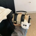 Straw woven handbag in beige and black leather with gold clasp and plush charm - Black