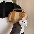 Straw cylinder bag with tan leather trim and a quirky furry monster bag charm - Khaki