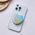 Macro detail of heart-shaped resin phone grip with blue and yellow gradient on phone - Magnetic Stand / Light Blue-Yellow Gradient (Gradient Heart-7)
