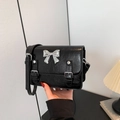 Retro black oil wax leather crossbody bag with silver bow accent and strap detail - Black