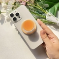 Détail de coque magnétique avec support orange transparent contenant un baume solide - Support Magnétique / Dégradé Orange Jaune - Couleur Unie