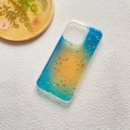 Detailed macro shot of blue and yellow gradient phone case with sparkling gold foil flakes - Ocean / Model 13