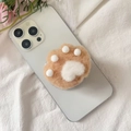 Close-up of cute plush cat paw phone socket on white smartphone with soft floral background - Magnetic Stand / Khaki Plush Cat Claw