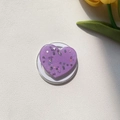 Detailed view of heart-shaped purple glitter phone grip with retractable white base - Magnetic Stand / Purple Silver Foil Glitter Heart