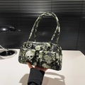 Gothic style shoulder bag with black skull and rose floral print featuring dual front pockets - Black