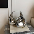 Silver patent leather crescent handbag set with gold chain strap on books - Silver