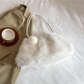 Chic white faux fur handbag with pom-pom charm and golden hardware on a white backdrop - White
