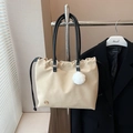 Minimalist beige tote bag with drawstring closure and soft fur ball charm detail - Khaki
