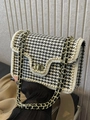 Houndstooth woven shoulder bag with pearl trim and gold chain strap in hand display - Black Check / Small