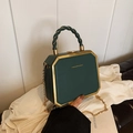 Dark green octagonal box bag with gold metal trim and braided handle detail - Dark Green