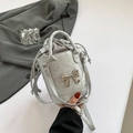 Silver metallic pleated bucket bag with bow detail and adjustable shoulder strap - Silver